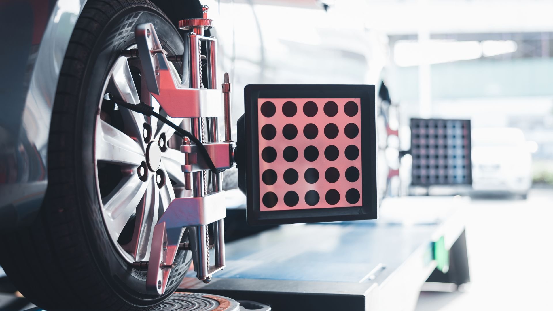 Wheel alignment machine with sensor targets checking car tire calibration