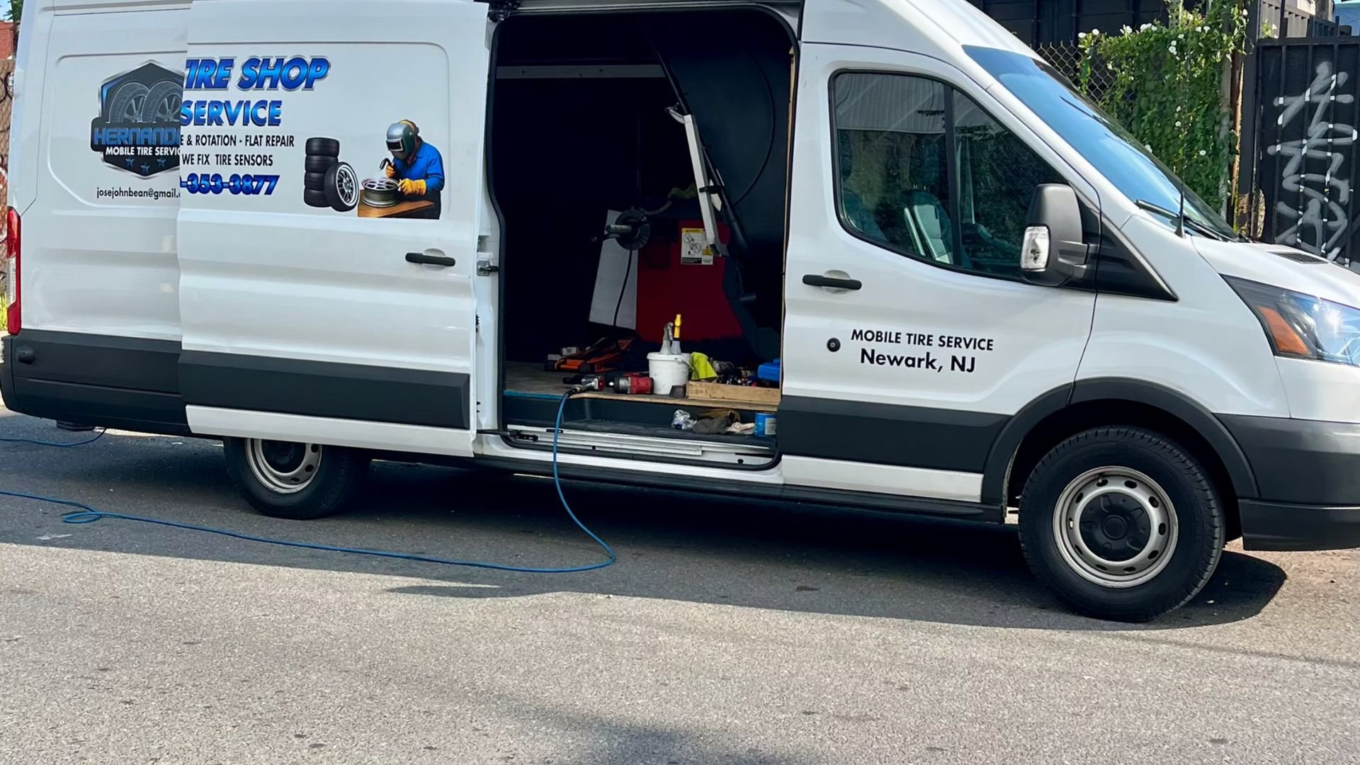 White mobile tire service van with open door in Newark, NJ